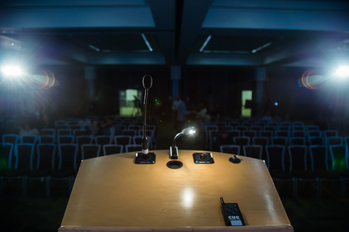 The podium light before an empty auditorium